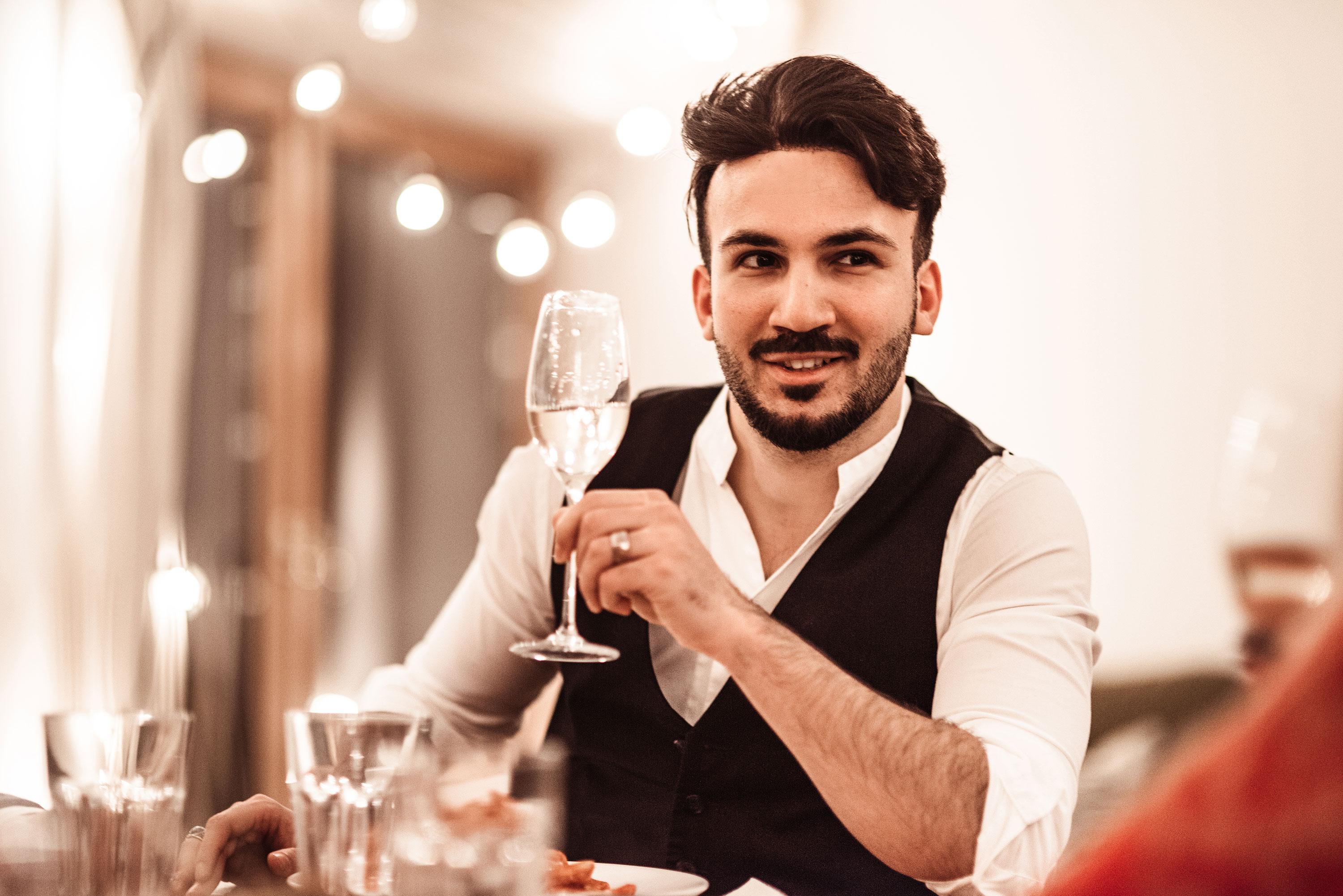 Man Drinking fromMan Wearing Black Vest Drinking Water from Wine Glass