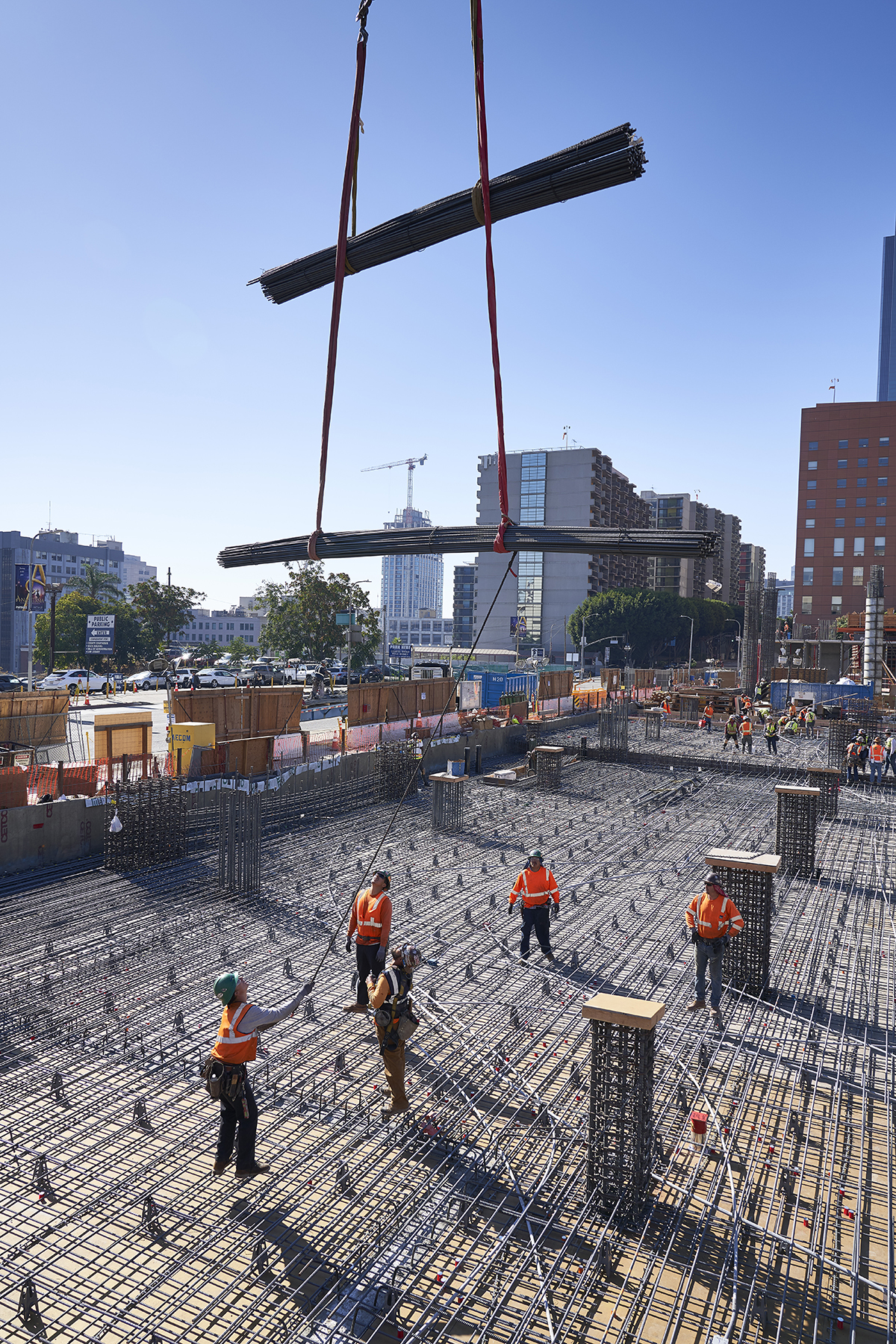 Construction Team Working on Development of The Grand, Crane Lifting Beams